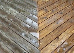 Before and after photo of a wooden deck that has been pressure washed